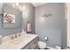 Updated half bathroom features vanity with marble countertop, modern fixtures and stylish decor at 5490 S Jellison St, Littleton, CO 80123