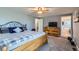 Well-lit bedroom with soft carpet, neutral colors, and an access to the ensuite bathroom at 5490 S Jellison St, Littleton, CO 80123