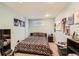 Bedroom featuring light blue walls, a patterned comforter, and assorted decorations at 5490 S Jellison St, Littleton, CO 80123
