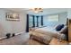 Relaxing bedroom with soft carpeting, large windows and a comfortable queen-sized bed at 5490 S Jellison St, Littleton, CO 80123