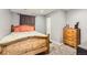 Bedroom with a wooden bed frame, light colored walls, and a wooden dresser with drawers at 5490 S Jellison St, Littleton, CO 80123