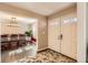 Inviting foyer with wood floors, neutral walls, and view of the dining room at 5490 S Jellison St, Littleton, CO 80123