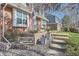 Close-up view of the home's entrance, showcasing a brick wall, garden, and steps at 5490 S Jellison St, Littleton, CO 80123