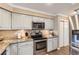 Stylish kitchen features stainless steel appliances, granite countertops and updated cabinets at 5490 S Jellison St, Littleton, CO 80123