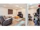 Cozy living room with wood-look floors, a comfortable couch and recliner, and a TV stand at 5490 S Jellison St, Littleton, CO 80123