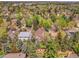 Aerial view of a home nestled in a green community with mature trees and colorful surroundings at 12362 E Vassar Dr, Aurora, CO 80014