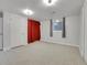 Carpeted basement has a window, closet, unique light fixtures, and curtains at 12362 E Vassar Dr, Aurora, CO 80014