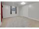 Carpeted basement featuring a closet and natural light from the window at 12362 E Vassar Dr, Aurora, CO 80014