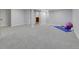 Finished basement offering a large area with soft carpeting, and storage at 12362 E Vassar Dr, Aurora, CO 80014