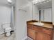 Simple bathroom featuring a single sink vanity and shower with blue curtain at 12362 E Vassar Dr, Aurora, CO 80014