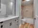 Charming bathroom showcasing light grey cabinets, granite counters, and a shower/tub combination at 12362 E Vassar Dr, Aurora, CO 80014