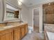 Bathroom featuring double sinks, granite countertops, and a walk-in shower with tile surround at 12362 E Vassar Dr, Aurora, CO 80014