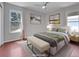 Bedroom featuring wood floors, neutral walls, ceiling fan, and staged furniture at 12362 E Vassar Dr, Aurora, CO 80014