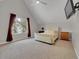 Cozy bedroom features an angled ceiling, neutral walls, and great natural light at 12362 E Vassar Dr, Aurora, CO 80014