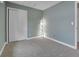 Cozy bedroom showcasing modern lighting, neutral walls, and a large closet with sliding doors at 12362 E Vassar Dr, Aurora, CO 80014