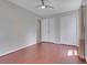 Bright bedroom featuring wood floors, a ceiling fan, and a large closet with doors at 12362 E Vassar Dr, Aurora, CO 80014