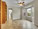 Dining room with modern chandelier, bay windows, tile flooring, and built-in shelving at 12362 E Vassar Dr, Aurora, CO 80014
