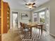 Staged dining room with modern chandelier, bay windows, and tile flooring at 12362 E Vassar Dr, Aurora, CO 80014