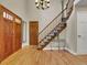 Bright foyer featuring hardwood floors, a staircase with carpet runner, and a decorative chandelier at 12362 E Vassar Dr, Aurora, CO 80014