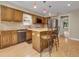 Kitchen offers stainless steel appliances, stone countertops, and a center island with seating at 12362 E Vassar Dr, Aurora, CO 80014