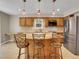 Kitchen boasts granite countertops, a breakfast bar, and stainless steel appliances at 12362 E Vassar Dr, Aurora, CO 80014