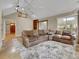 Spacious living room featuring a large sectional sofa and vaulted ceilings at 12362 E Vassar Dr, Aurora, CO 80014