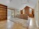Spacious living room with vaulted ceiling, brick fireplace, built-in shelving, and tile flooring at 12362 E Vassar Dr, Aurora, CO 80014