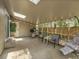 Screened-in patio enhanced by comfortable seating, string lights, and a view of the backyard at 12362 E Vassar Dr, Aurora, CO 80014
