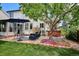 Spacious backyard with patio, seating, lush lawn, and a hot tub at 6836 Edgewood Way, Highlands Ranch, CO 80130
