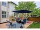 Backyard featuring a patio with seating area, mature tree, and privacy fence at 6836 Edgewood Way, Highlands Ranch, CO 80130