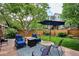 Landscaped backyard featuring a patio, seating, and a well-maintained lawn at 6836 Edgewood Way, Highlands Ranch, CO 80130