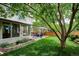 Backyard featuring a large tree, patio, hot tub, and greenery at 6836 Edgewood Way, Highlands Ranch, CO 80130