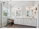 Bright bathroom with double vanity, updated lighting, walk-in shower, and a separate makeup vanity at 6836 Edgewood Way, Highlands Ranch, CO 80130