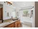 Bathroom with vanity, framed mirror, tub, shower, and window at 6836 Edgewood Way, Highlands Ranch, CO 80130