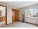 Bedroom featuring neutral paint, a window, carpet flooring, and a closet at 6836 Edgewood Way, Highlands Ranch, CO 80130