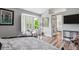 Well-lit bedroom boasts wood floors, comfortable seating, and decorative touches at 6836 Edgewood Way, Highlands Ranch, CO 80130