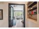 A welcoming glimpse through a doorway to a sitting room, with modern grey paint and wood floors at 6836 Edgewood Way, Highlands Ranch, CO 80130