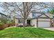 Inviting home with mature tree, manicured lawn, and charming front porch seating at 6836 Edgewood Way, Highlands Ranch, CO 80130