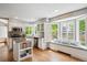 Eat-in kitchen with stainless steel appliances, white cabinetry, and sun-filled breakfast nook at 6836 Edgewood Way, Highlands Ranch, CO 80130