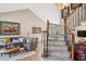 Inviting living room with decorative staircase and hardwood floors at 6836 Edgewood Way, Highlands Ranch, CO 80130