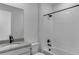 Bathroom featuring black hardware, white tile, and neutral countertop at 1422 Hudson Pl, Longmont, CO 80501