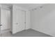 A minimalistic bedroom showcases a large closet, neutral carpet, and white walls at 1422 Hudson Pl, Longmont, CO 80501