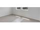 Bright bedroom with two windows and clean carpeting, providing ample natural light at 1422 Hudson Pl, Longmont, CO 80501