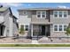 Inviting two-story townhome with stone accents, a covered front porch, and tidy landscaping at 1422 Hudson Pl, Longmont, CO 80501