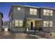 Charming townhome showcases stone accents, a welcoming front porch and professionally landscaped yard at 1422 Hudson Pl, Longmont, CO 80501