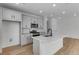 Stylish kitchen featuring stainless appliances, white cabinets, and a central island perfect for cooking and entertaining at 1422 Hudson Pl, Longmont, CO 80501