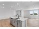 Bright kitchen features a stylish island with stainless steel appliances, a sink, and gorgeous countertops at 1422 Hudson Pl, Longmont, CO 80501