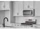 Close-up of a modern kitchen with stainless appliances, sleek countertops, and stylish backsplash perfect for cooking at 1422 Hudson Pl, Longmont, CO 80501
