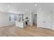 Modern open-concept kitchen featuring an island, white cabinetry, stainless steel appliances, and wood floors at 1422 Hudson Pl, Longmont, CO 80501