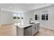 Bright kitchen features a stylish island with stainless steel appliances, a sink, and gorgeous countertops at 1422 Hudson Pl, Longmont, CO 80501